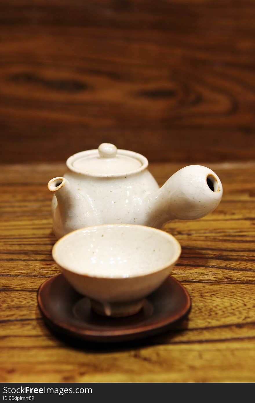 White Asian tea pot and cup - home interiors. White Asian tea pot and cup - home interiors