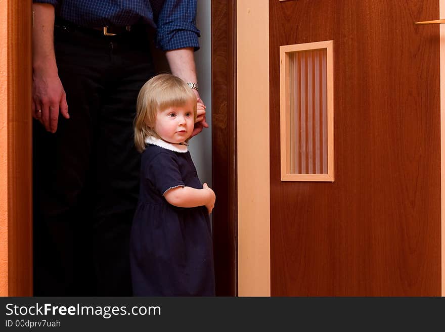 Cute little girl with blond hair holding her father's hand. Cute little girl with blond hair holding her father's hand