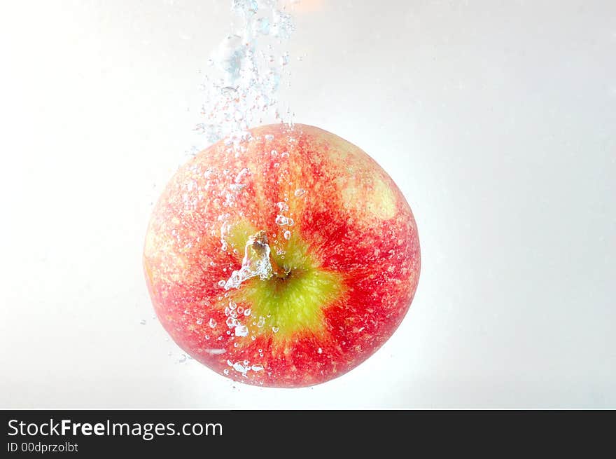 Apple thrown into water. High speed photography. Apple thrown into water. High speed photography.