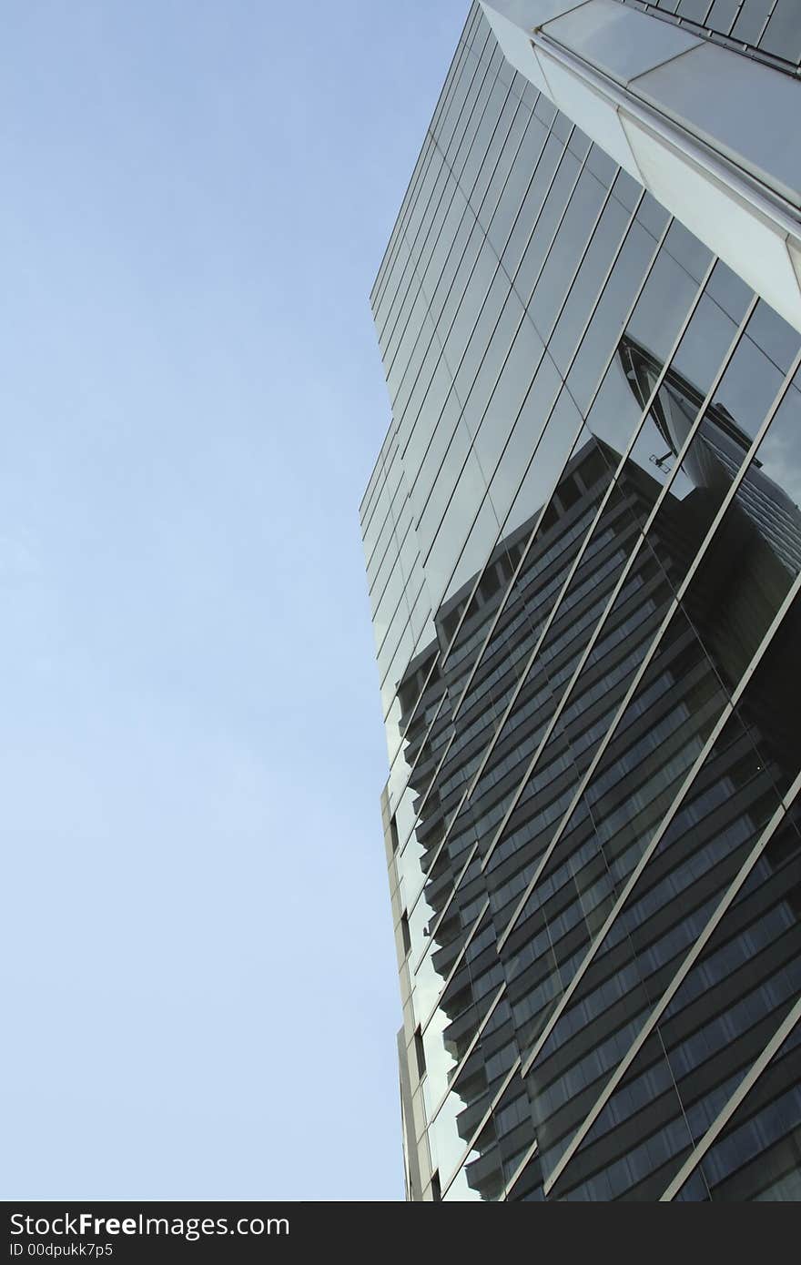 Modern architectural lines and reflections against a cloudy sky. Modern architectural lines and reflections against a cloudy sky