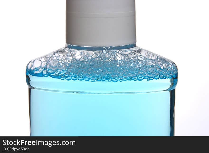 Made a foam blue cleaning liquid in a plastic vessel on a white background