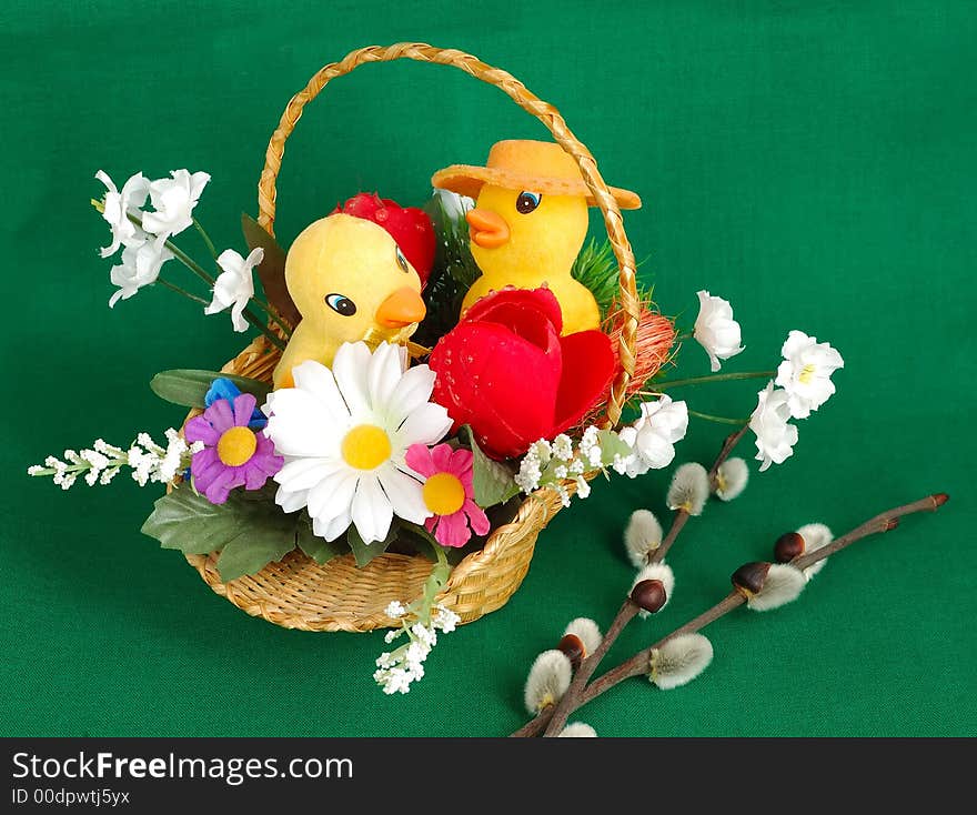 Easter basket with duckling on green