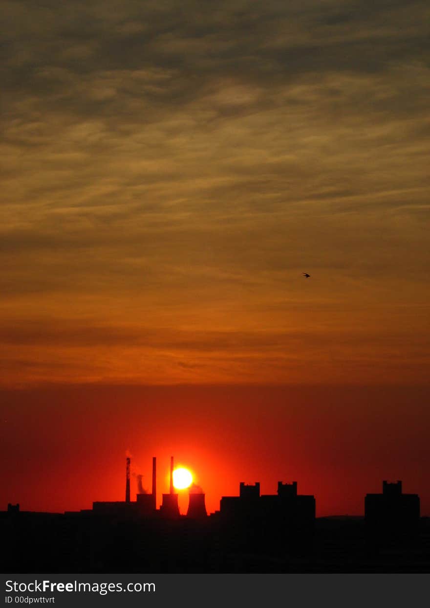 City stands out against the red sky; silhouette.