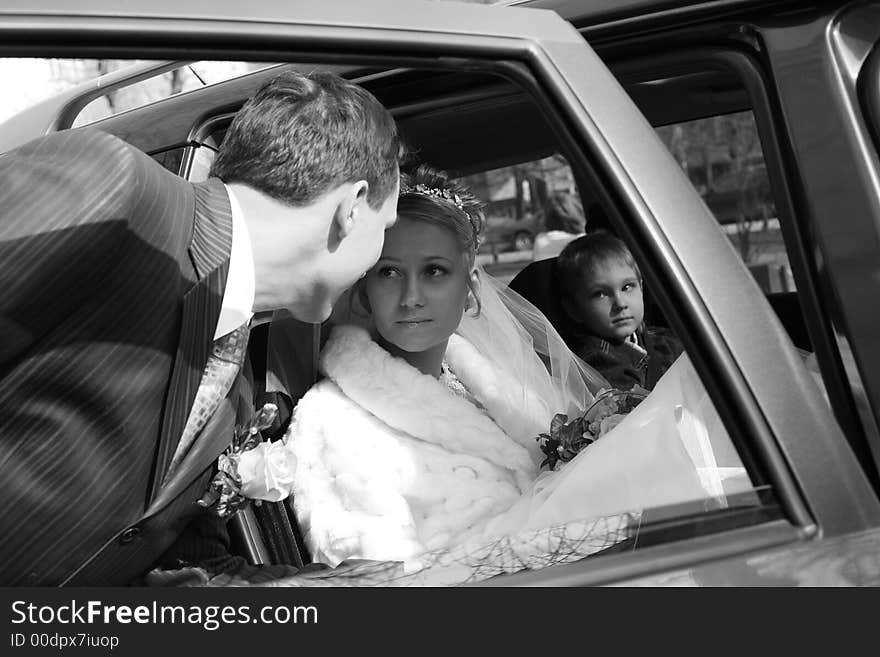 The bride with the little boy in the machine and seeing off groom. b/w. The bride with the little boy in the machine and seeing off groom. b/w