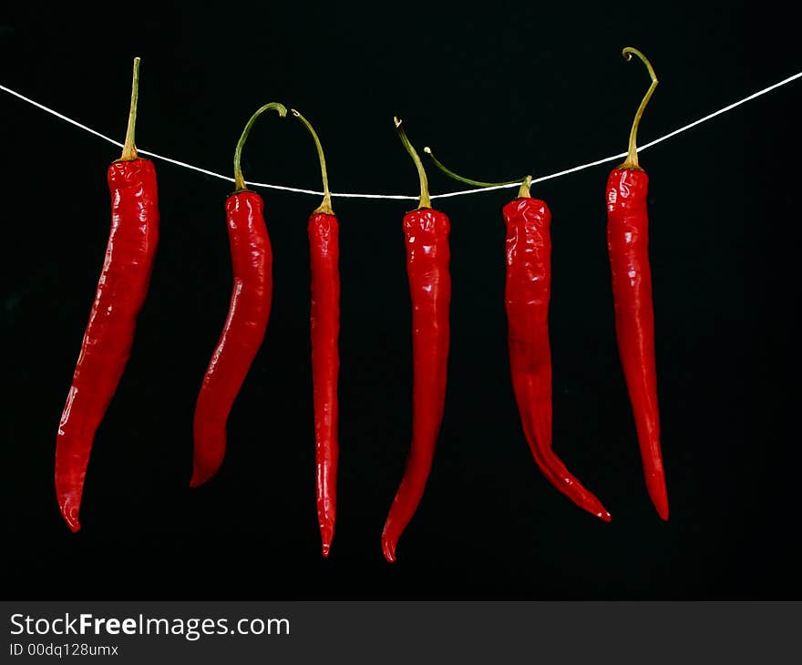 Red hot peppers isolated on black background. Red hot peppers isolated on black background