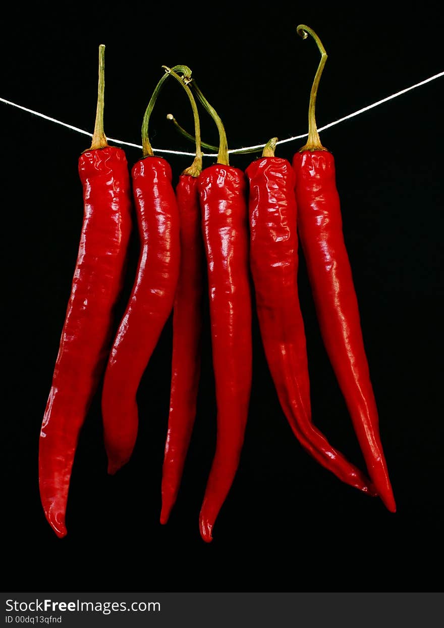 Red hot peppers isolated on black background. Red hot peppers isolated on black background