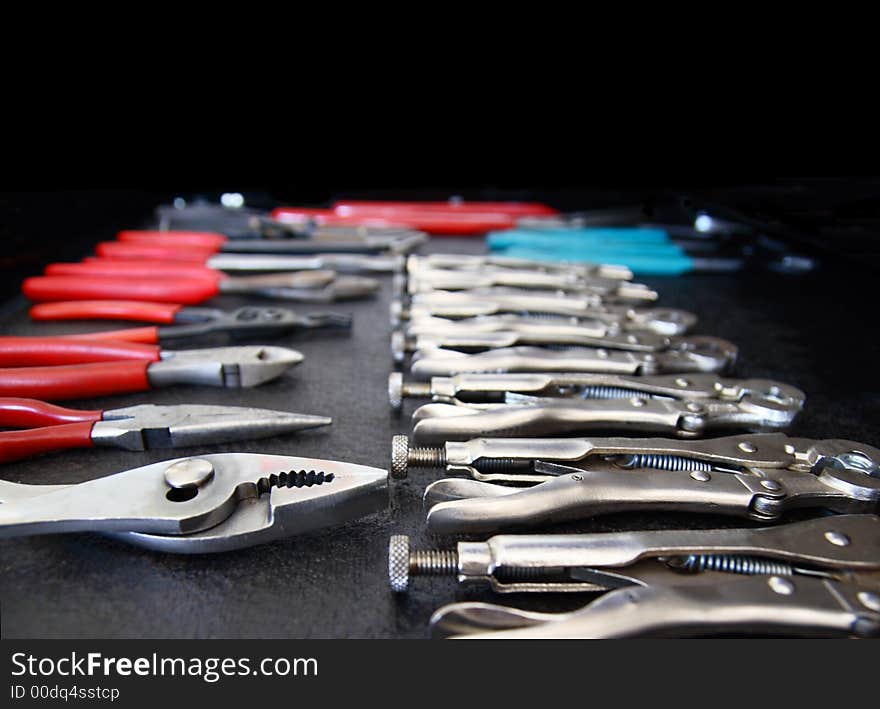 Layed out set of pliers with soft focus background blur bokeh. Room for text. Layed out set of pliers with soft focus background blur bokeh. Room for text