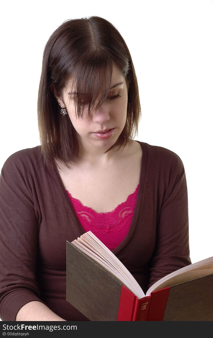 Young woman reading a hardcover book.