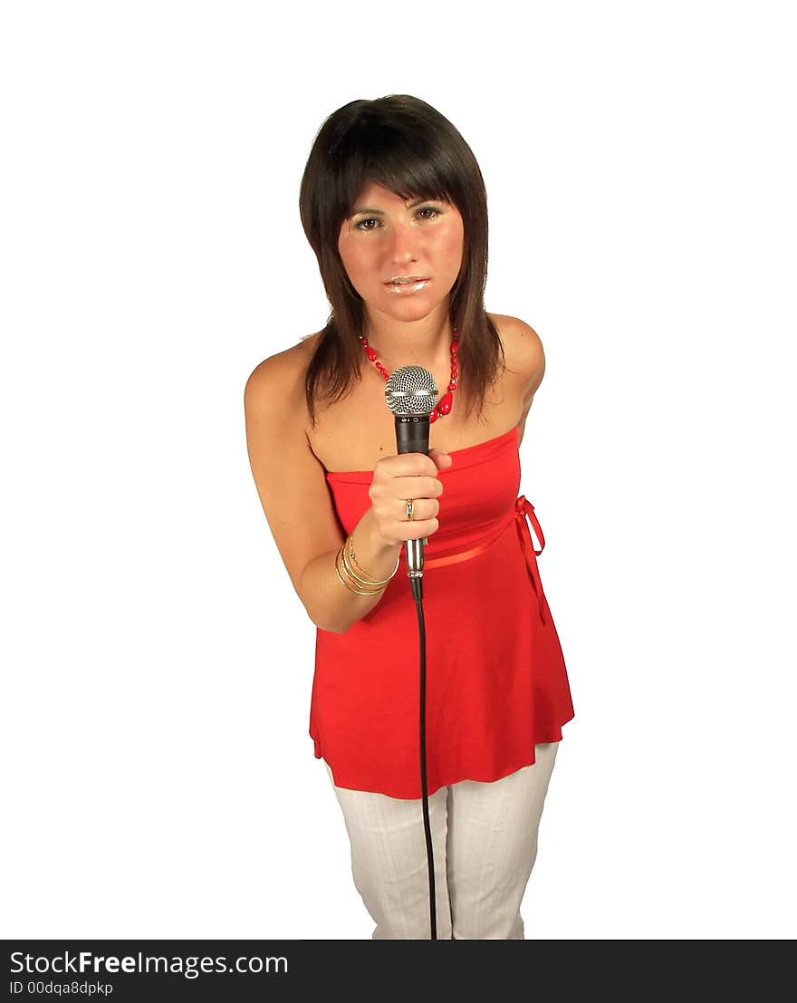 Young woman singing or talking with a microphone looking at the camera isolated over white background. Young woman singing or talking with a microphone looking at the camera isolated over white background