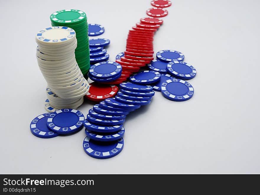 A background of scattered poker chips in white background