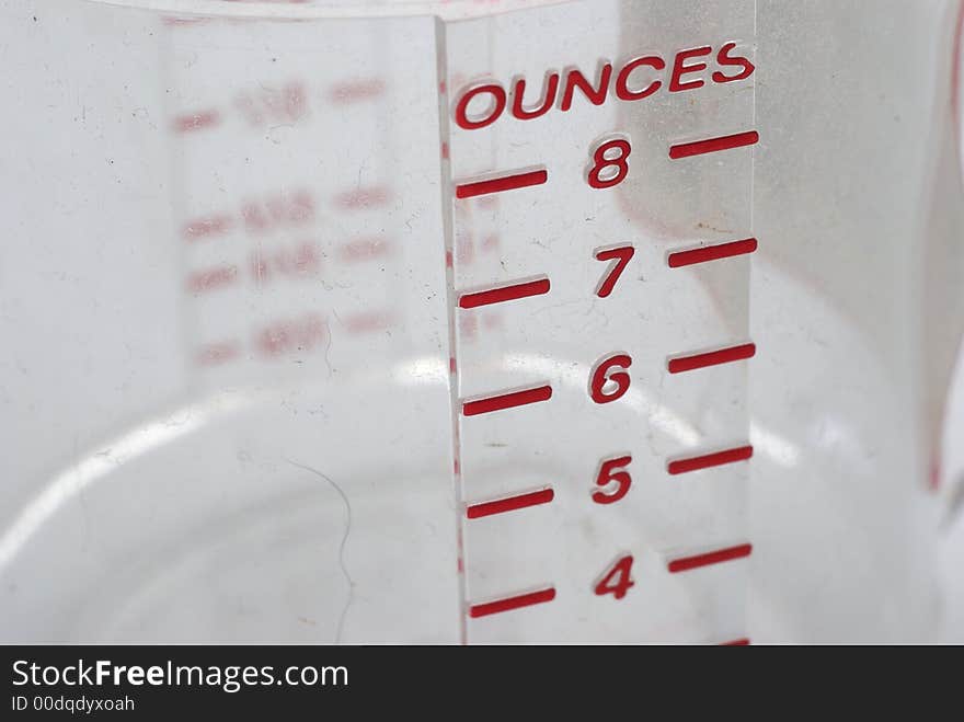 A close up of a measuring cup with ounce measurement. A close up of a measuring cup with ounce measurement