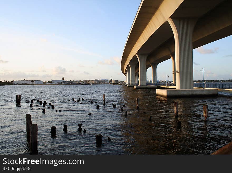 Tall bridge over fishing dock recreation area on the river. Tall bridge over fishing dock recreation area on the river.