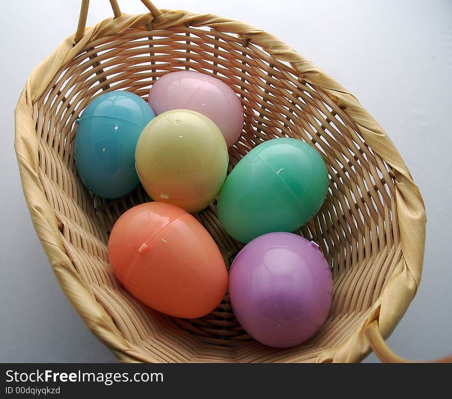 Multi-colored easter eggs in a basket. Multi-colored easter eggs in a basket