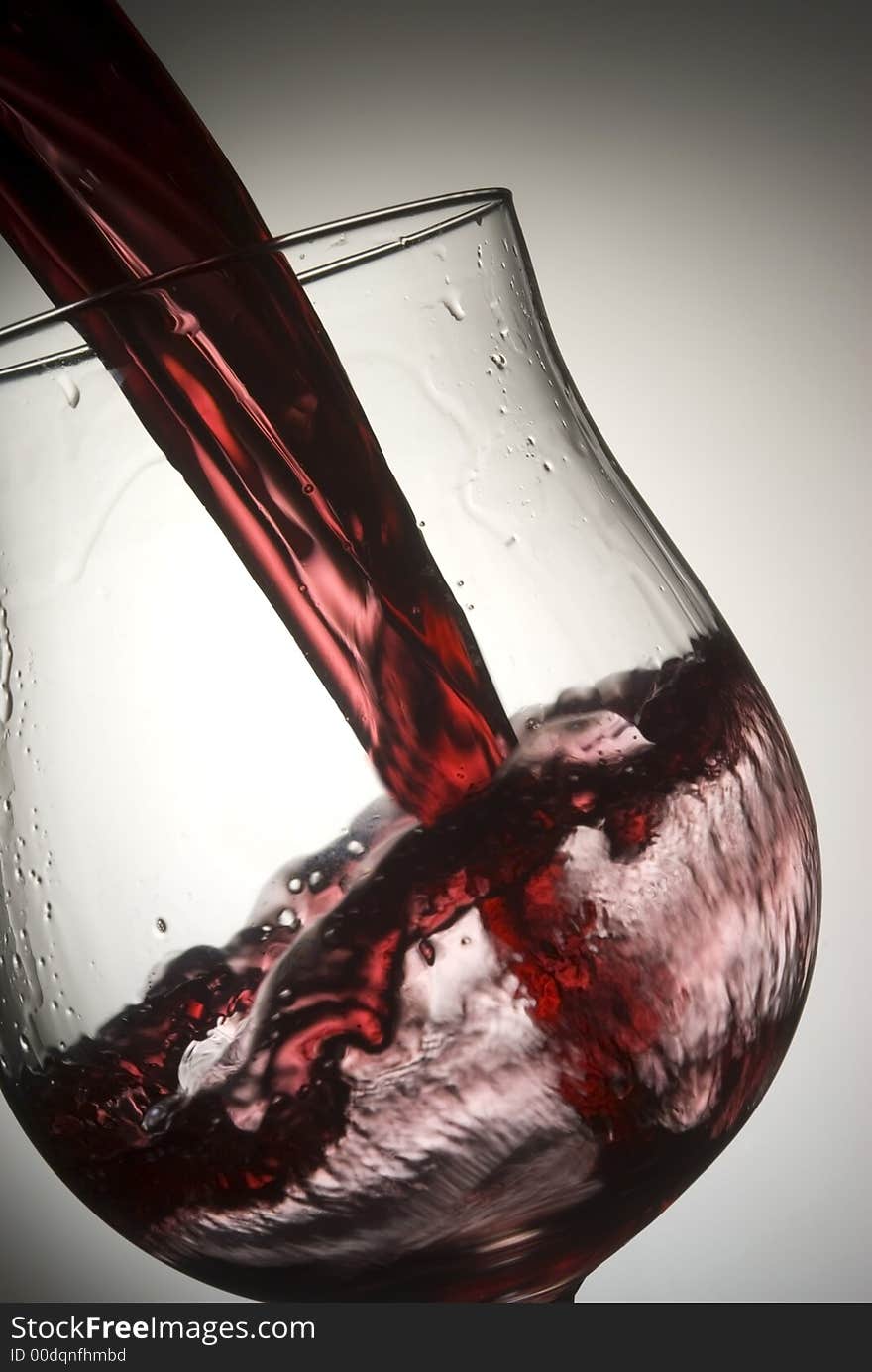 Red wine splashing in glass. Red wine splashing in glass