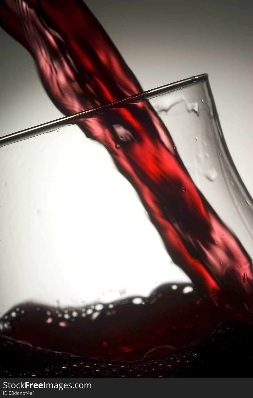 Red wine splashing in glass. Red wine splashing in glass