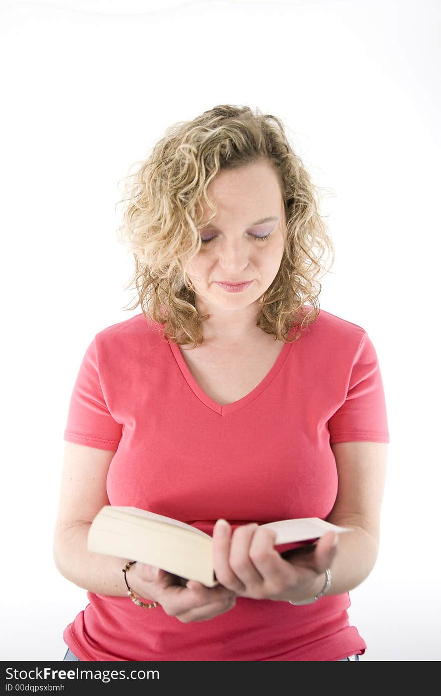 Attractive blonde reading a book isolated on white