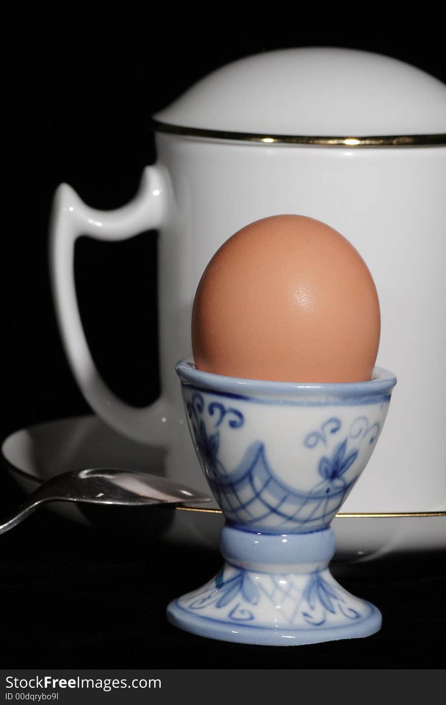 Egg on the support, cup, saucer and tea spoon. Egg on the support, cup, saucer and tea spoon.