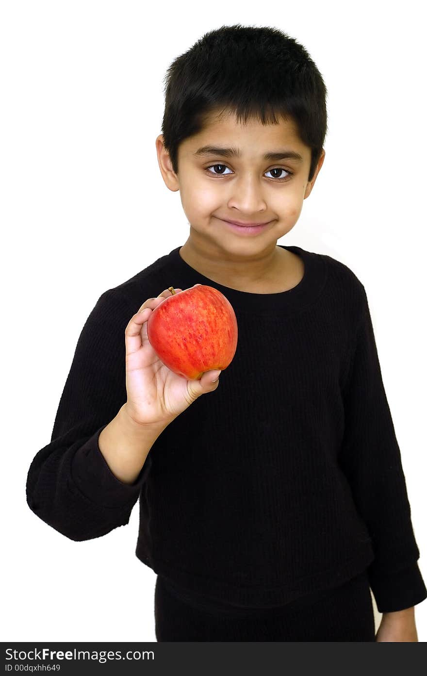 An handsome indian kid holding a red apple. An handsome indian kid holding a red apple