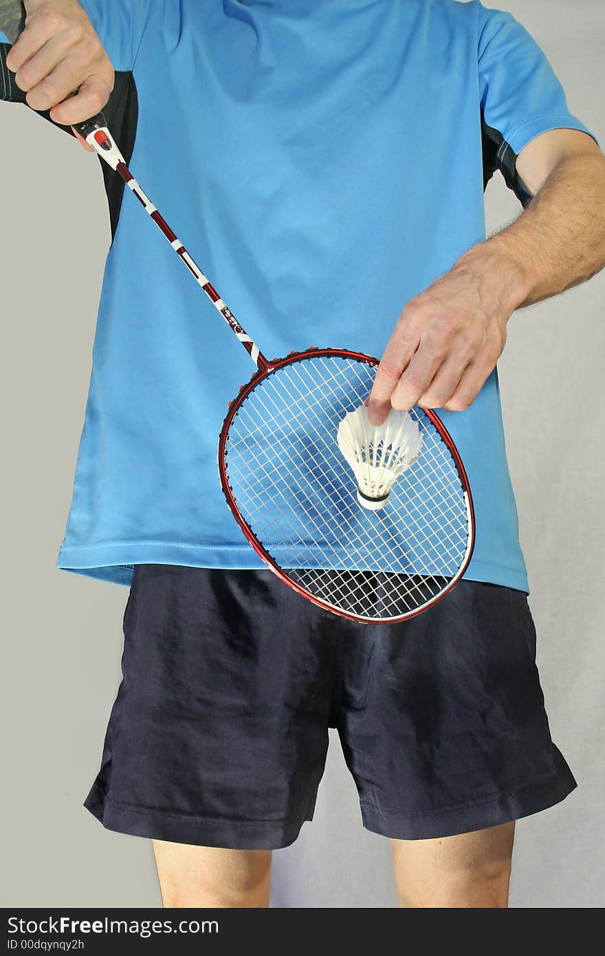 Player makes a badminton serve isolated on a white background