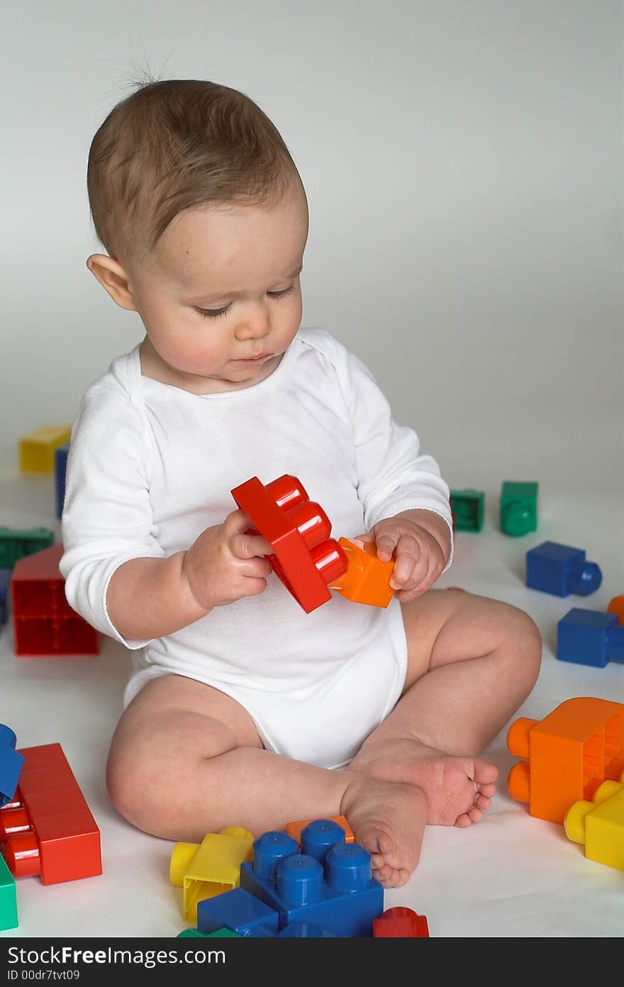 Image of cute baby playing with colorful building blocks. Image of cute baby playing with colorful building blocks