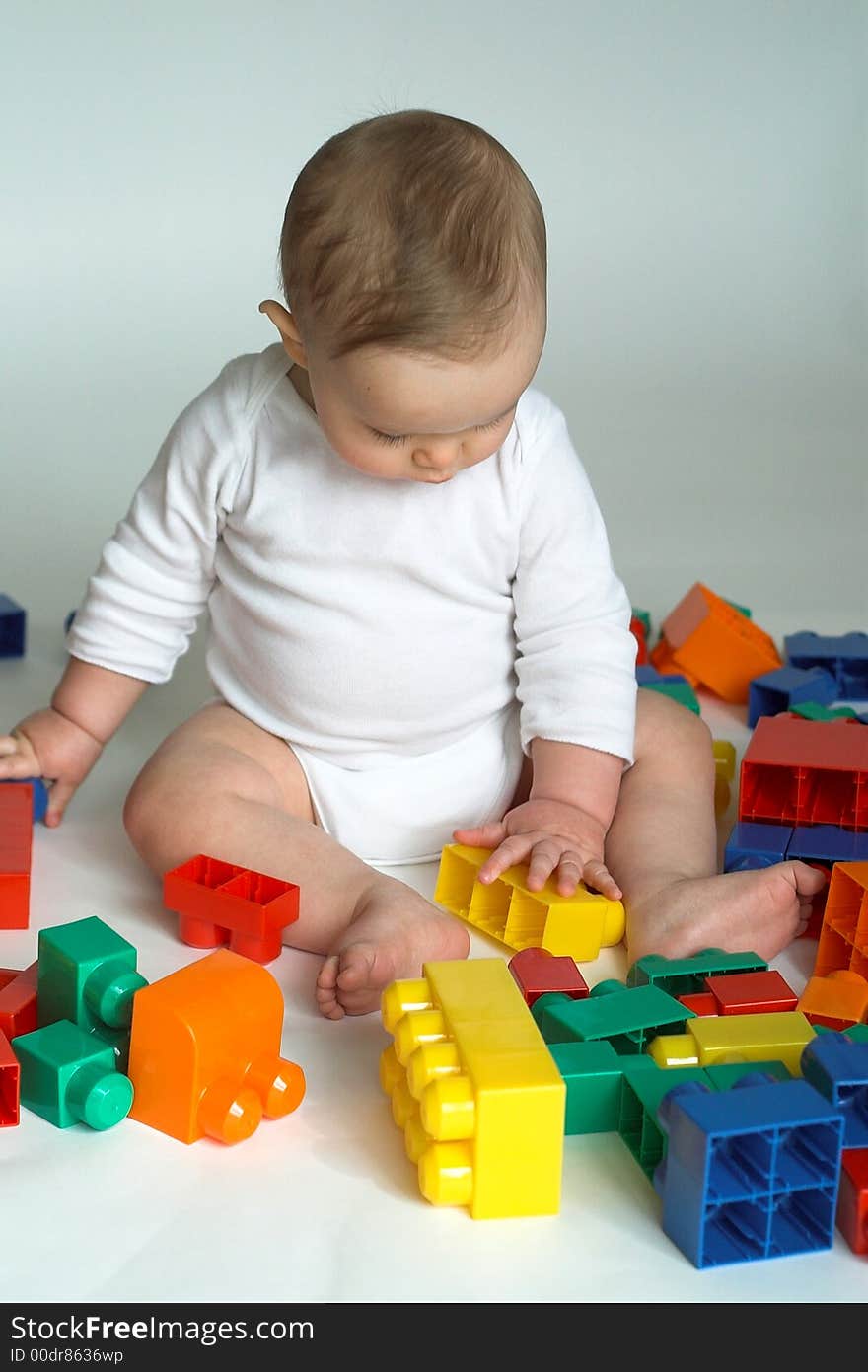 Image of cute baby playing with colorful building blocks. Image of cute baby playing with colorful building blocks