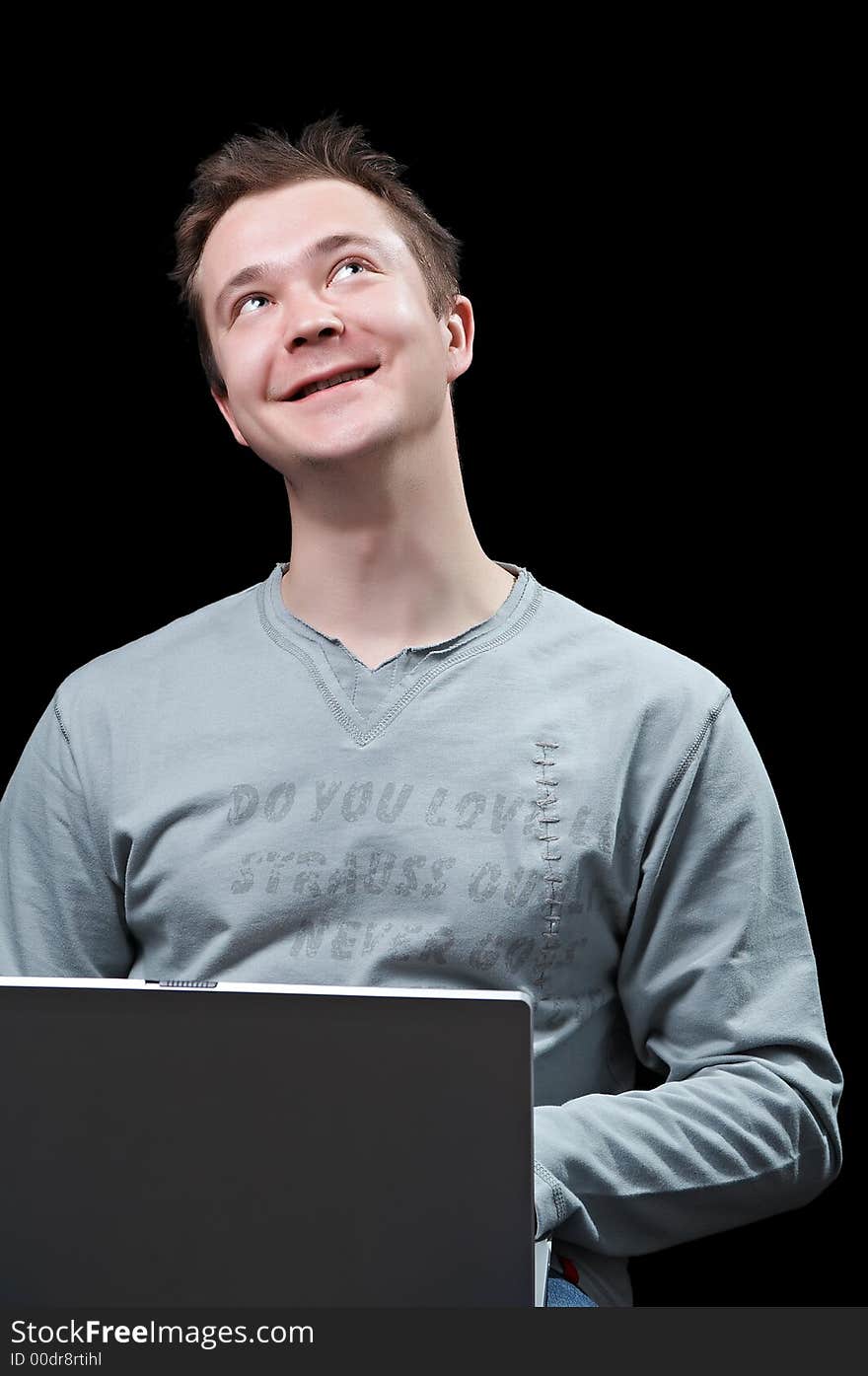 Young man with a notebook, pensively looking upwards. Young man with a notebook, pensively looking upwards