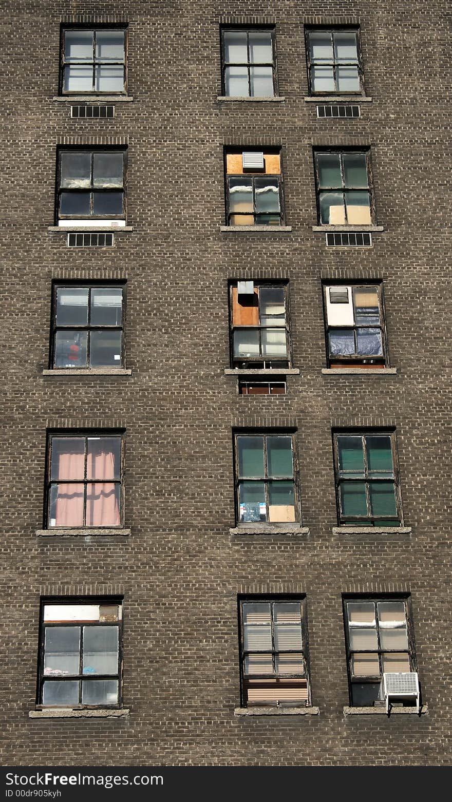 Three rows of windows of an old brick house.