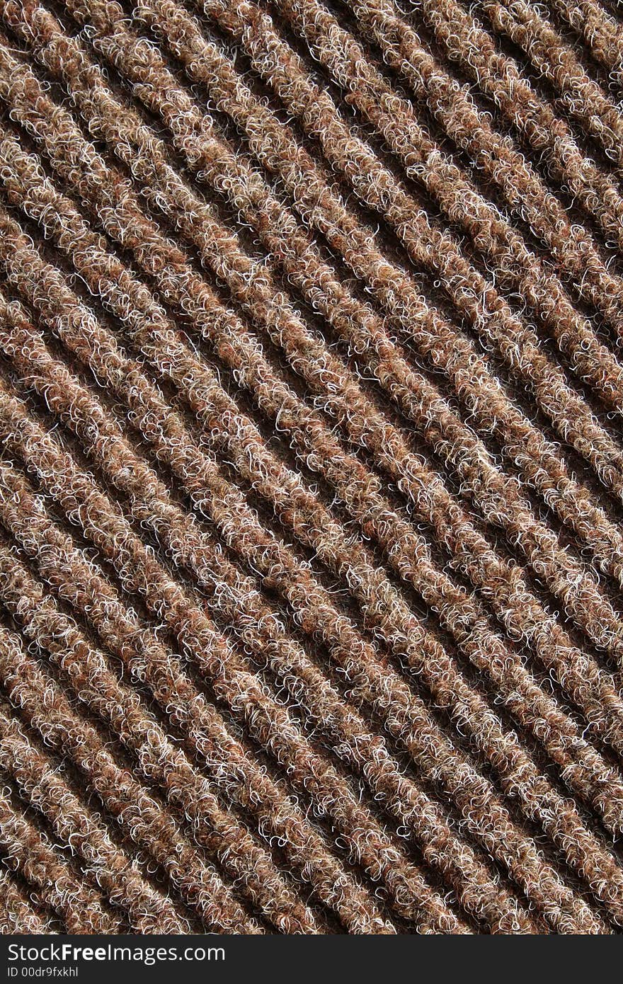 Diagonal lines of a brown striped fabric of a carpet. Diagonal lines of a brown striped fabric of a carpet.