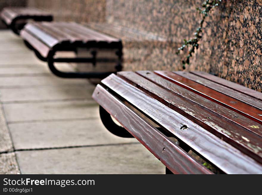 An abstract array of benches outside a modern building