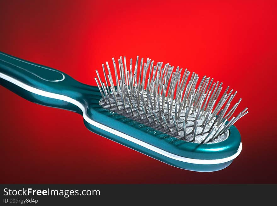 Hairbrush for hair on a dark red background