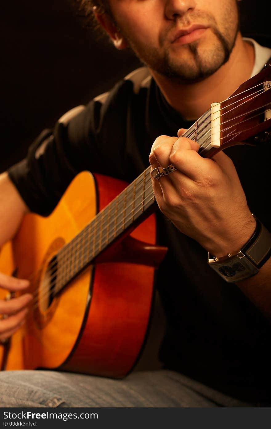 Rock star plays acoustic guitar on stage with great lights. Rock star plays acoustic guitar on stage with great lights