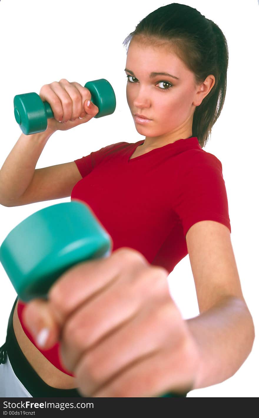 Girl in red sports vest fulfill movement by dumbbells. Girl in red sports vest fulfill movement by dumbbells