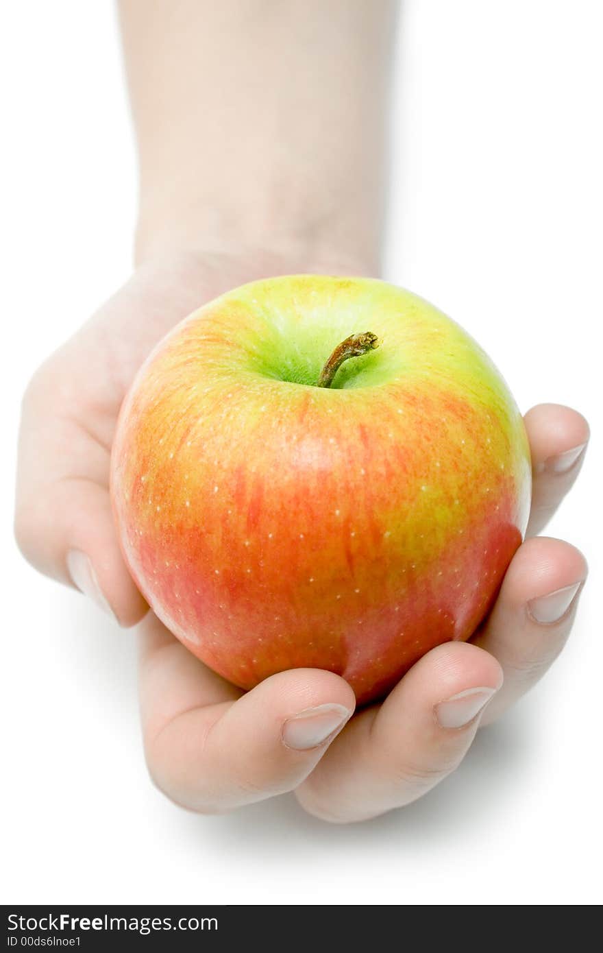 Female hand offering a colorful apple. Isolated on a white background. Female hand offering a colorful apple. Isolated on a white background.