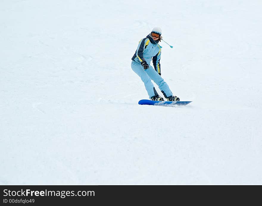 A girl riding on the snowboard