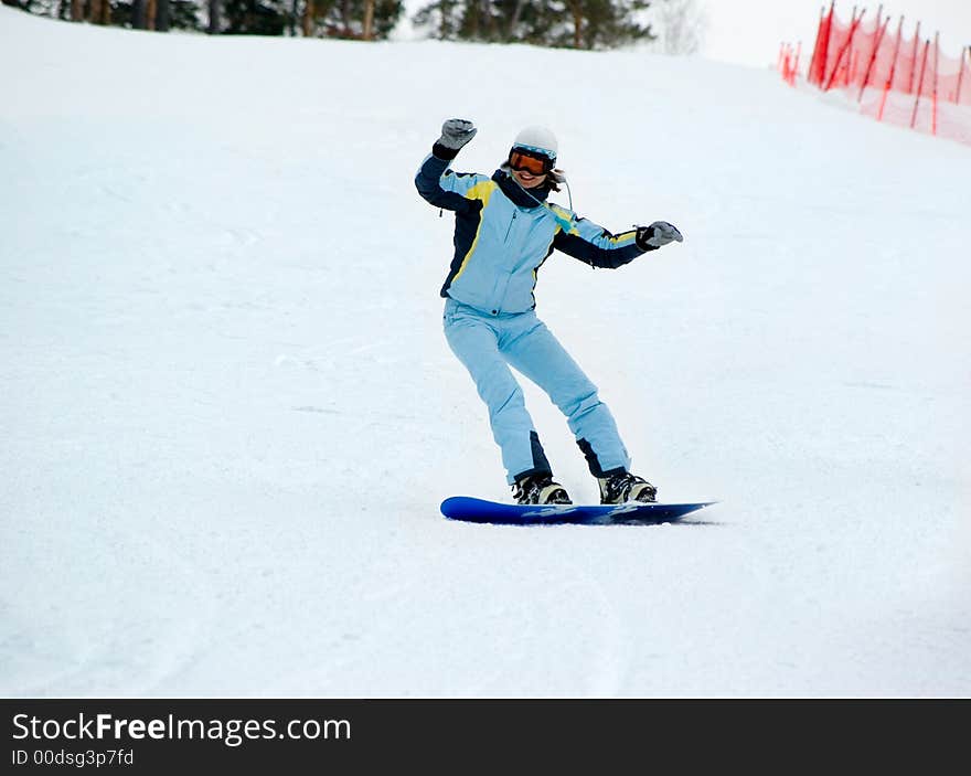 Smiling girl on the snowboard