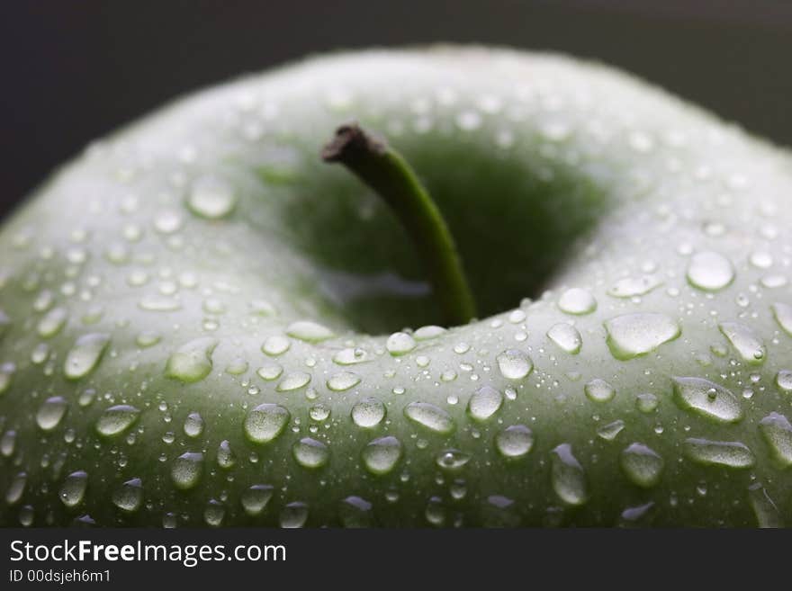 Wet green apple with stem