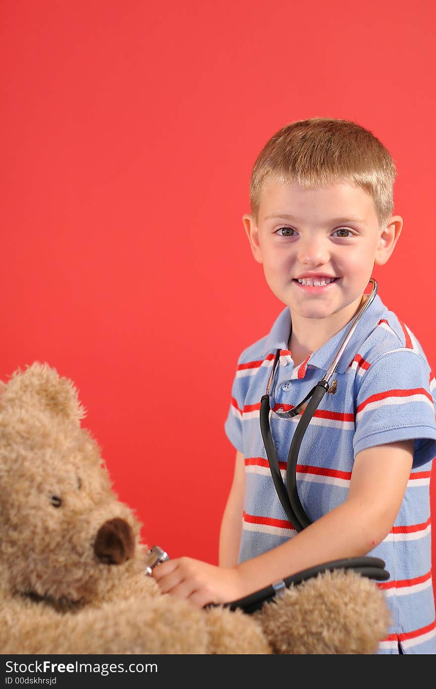 Shot of a little boy checking bears heartbeat vertical. Shot of a little boy checking bears heartbeat vertical