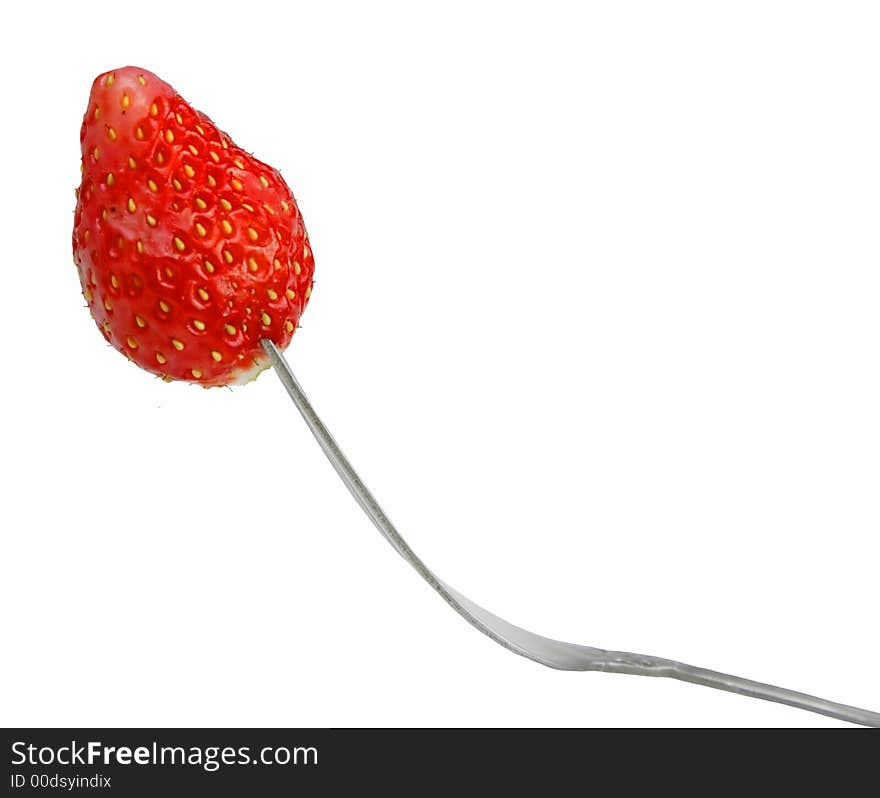 Strawberry in fork isolated over white background.