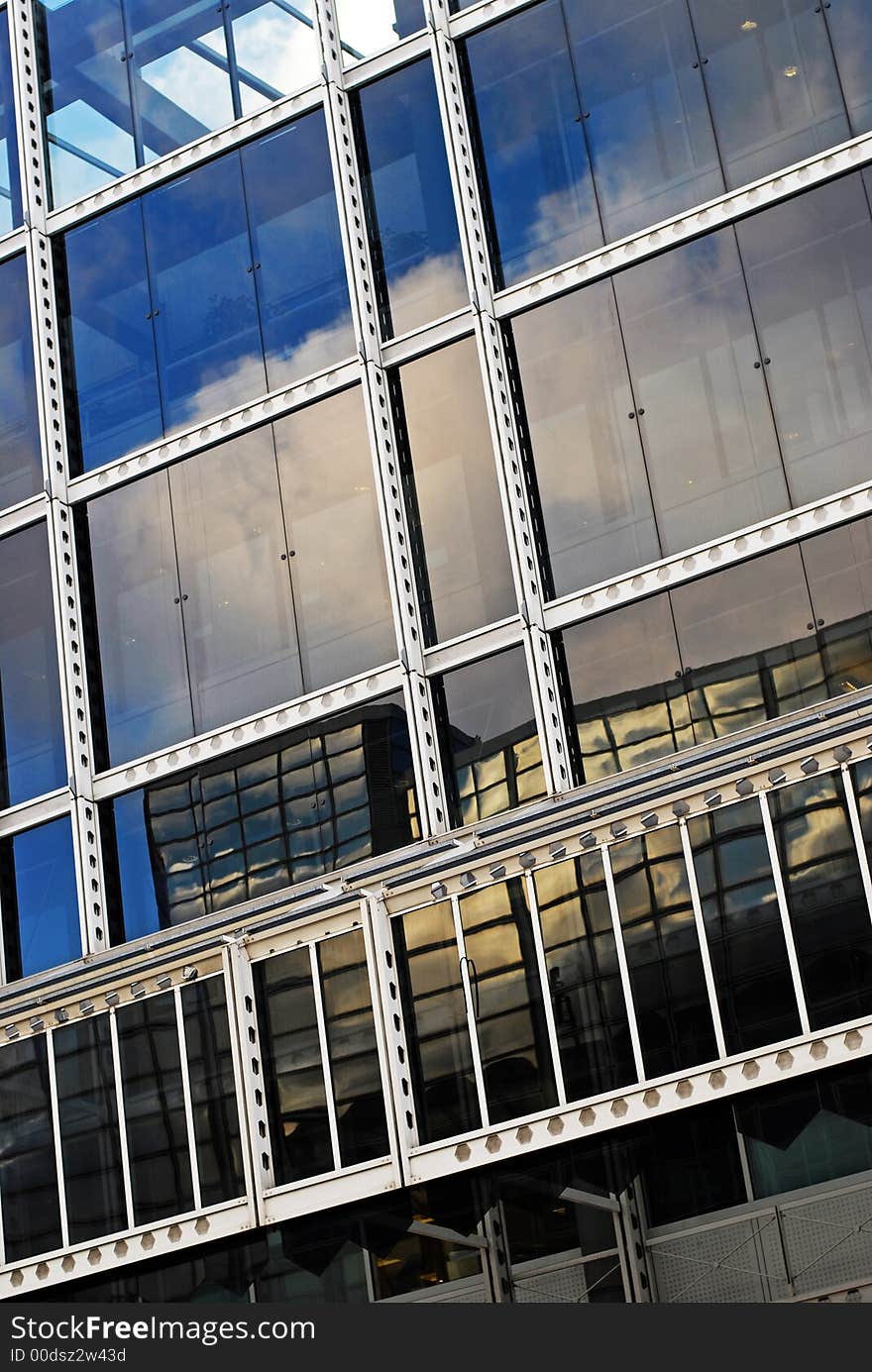 Reflections of clouds in a glass office building. Reflections of clouds in a glass office building.