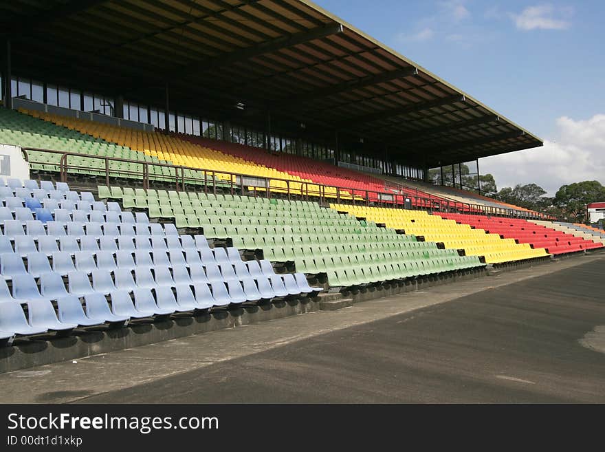 Many Empty Seats In Rows In An Outdoor Stadium. Many Empty Seats In Rows In An Outdoor Stadium