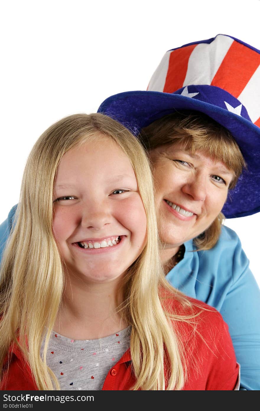 A cute american girl and her mother dressed for the Fourth of July holiday. Isolated on white. A cute american girl and her mother dressed for the Fourth of July holiday. Isolated on white.