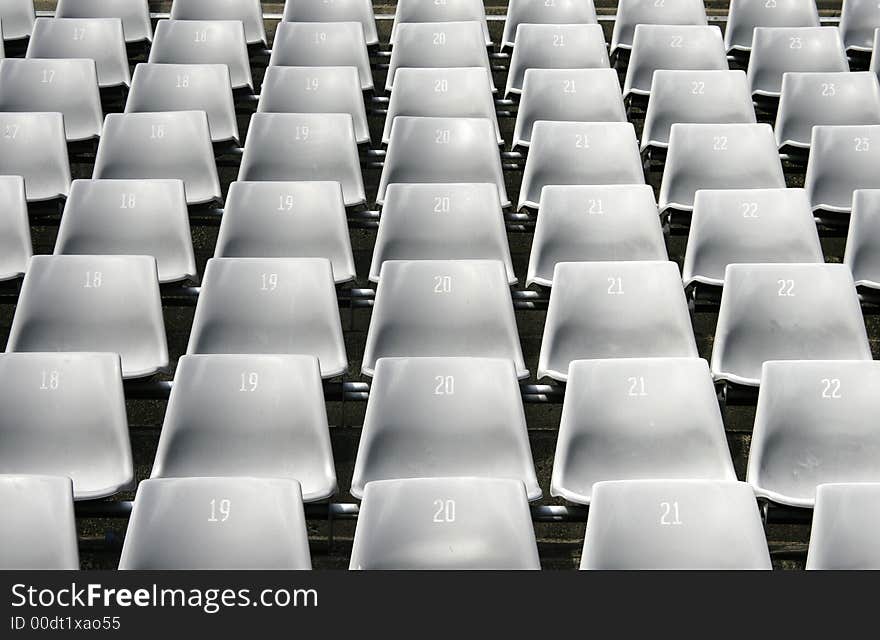 Many Empty Seats In Rows In An Outdoor Stadium. Many Empty Seats In Rows In An Outdoor Stadium