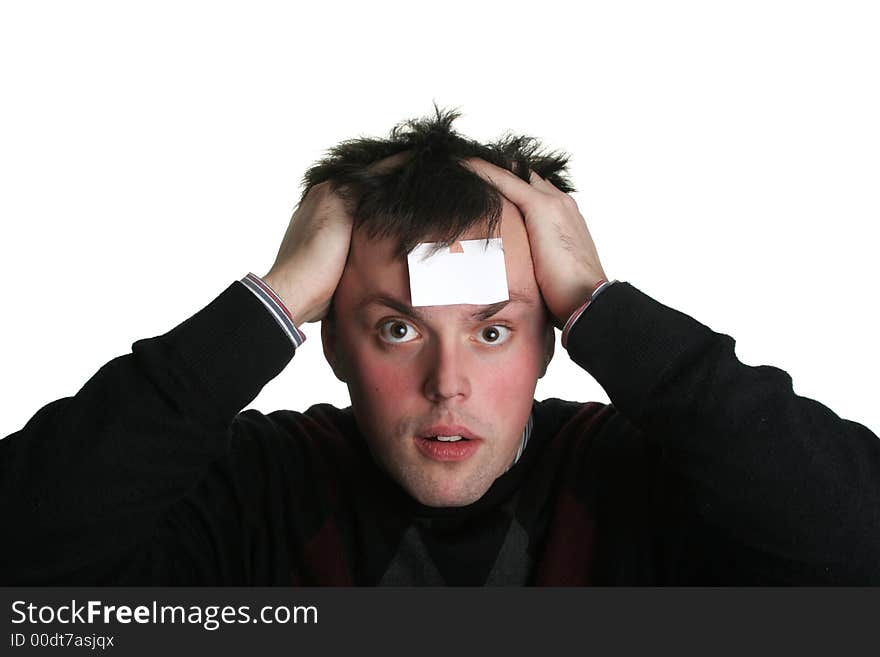 Young man with crazy eyes and blank piece of paper on his forehead. Young man with crazy eyes and blank piece of paper on his forehead