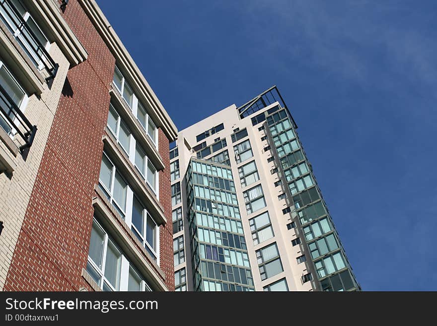 Two new condominium developments with a vivid blue sky in the background. Two new condominium developments with a vivid blue sky in the background.