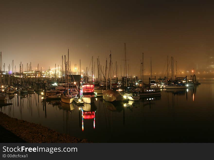 Late at night with the fog settling in above the marina. Late at night with the fog settling in above the marina.