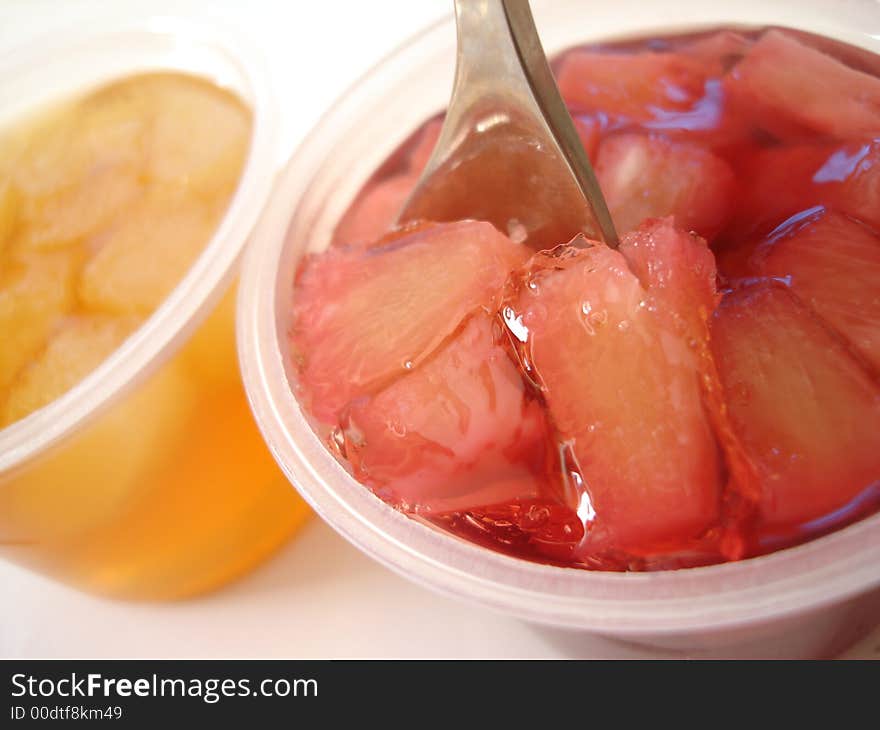 Red and yellow jelly with spoon