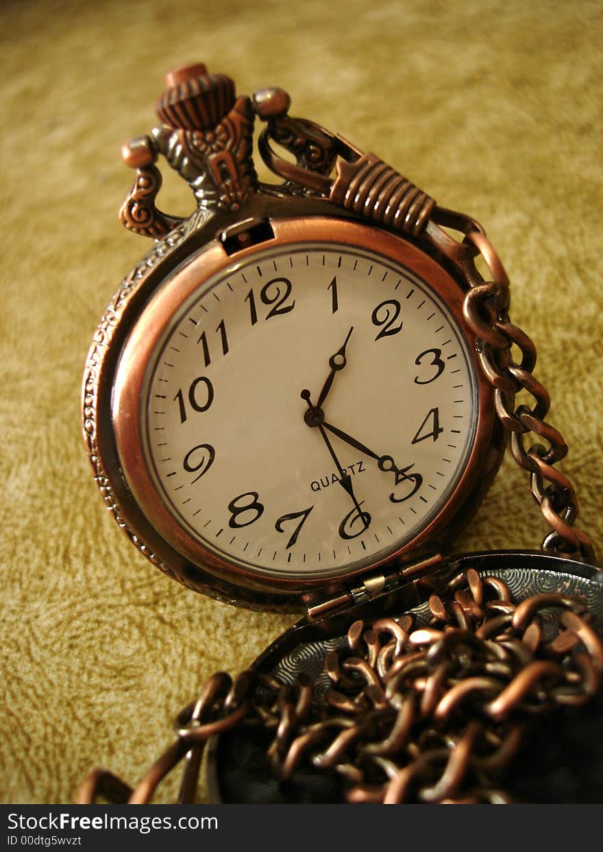 Close-up of old golden clock on vintage background