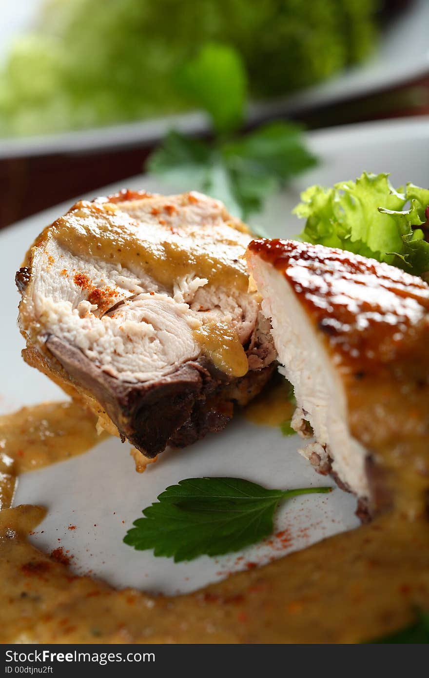 Oven chicken with dressing and salad on the white plate