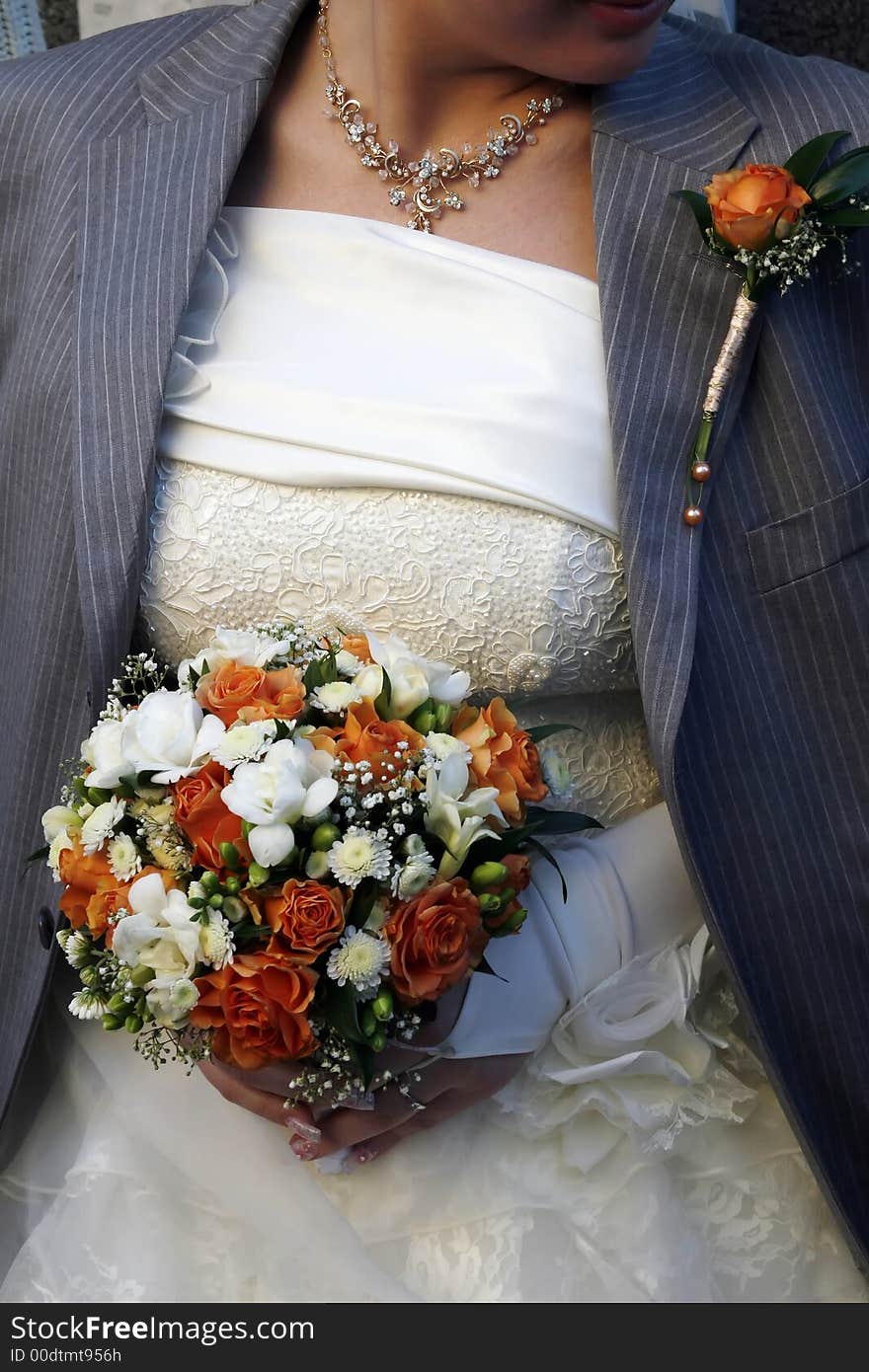 The groom has thrown shoulders her bride with the jacket to warm the young wife in the street after ceremony