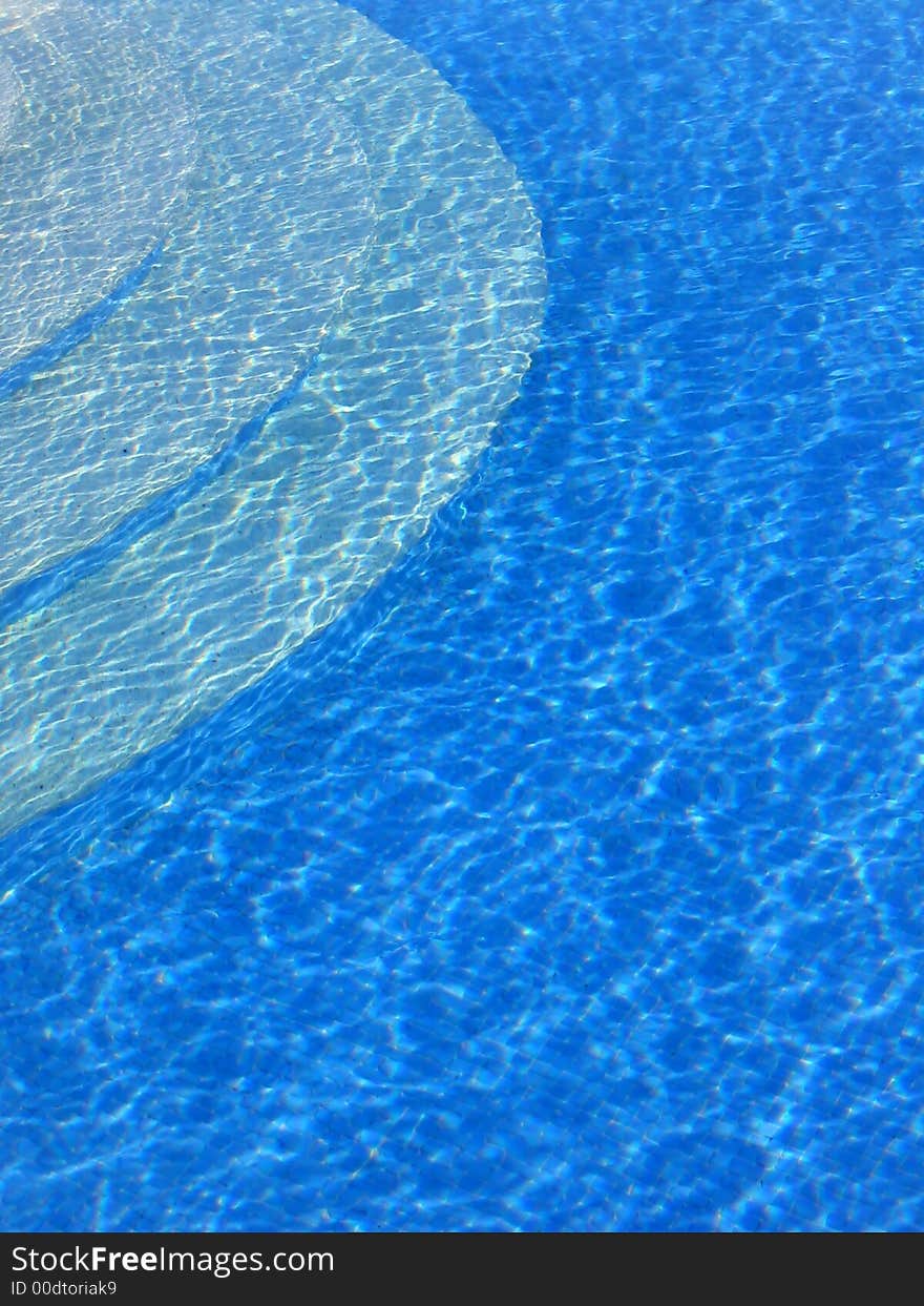 Swimming pool steps and blue water